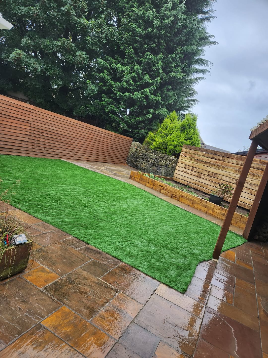 Artificial grass in an enclosed paved garden