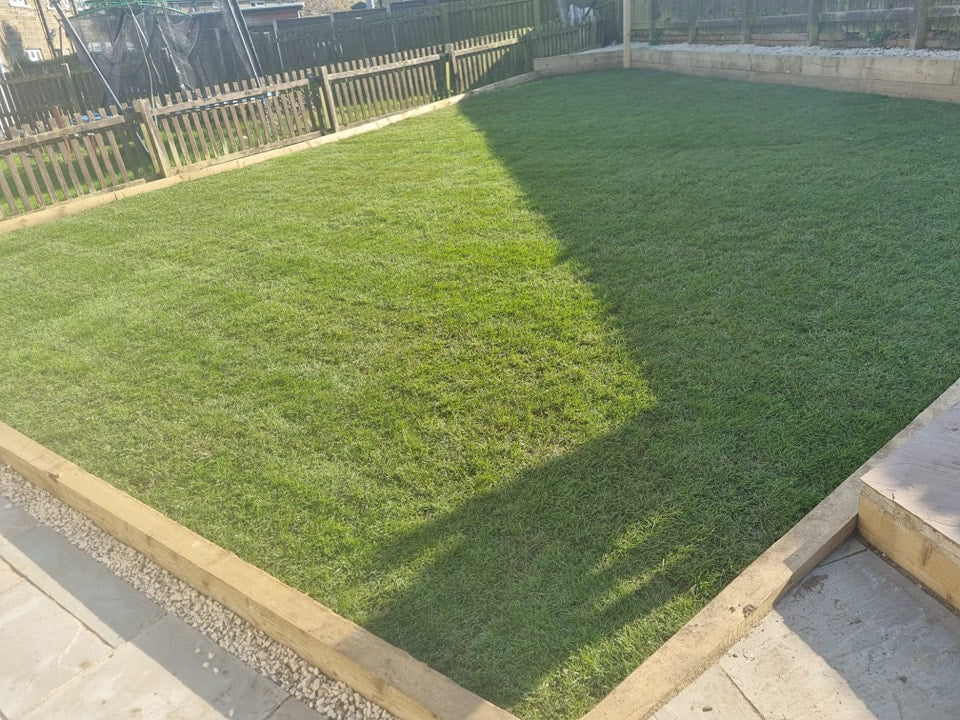 Lawn with timber edging and boundary fencing