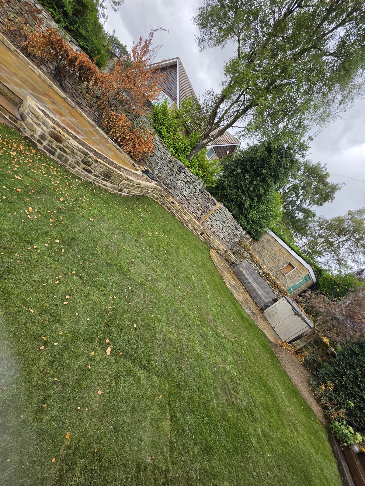 Garden lawn beside curved stone retaining walls