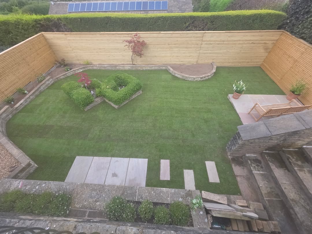 Enclosed garden lawn with raised timber beds