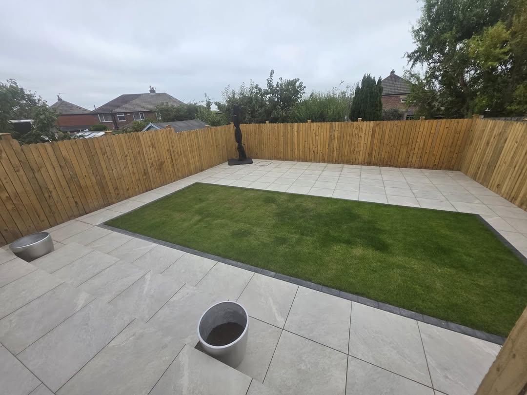 Garden lawn framed by paving and timber fencing